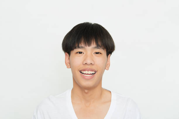 istock Close up portrait Young Man Smiling Happy on white 1285396540
