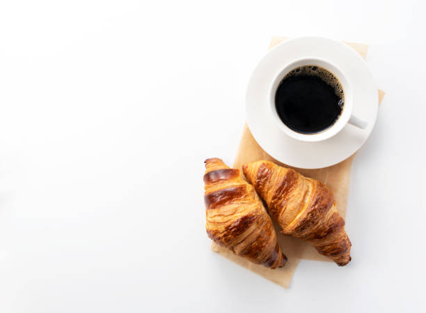 istock Croissants and hot coffee on a white background with a copy space 1285397782