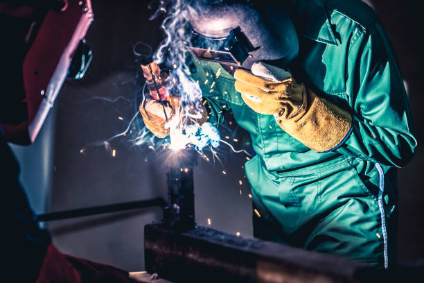 istock Metal welding steel works using electric arc welding machine 1285398608