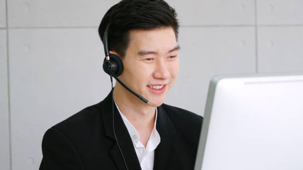 istock Business people wearing headset working in office 1285399190