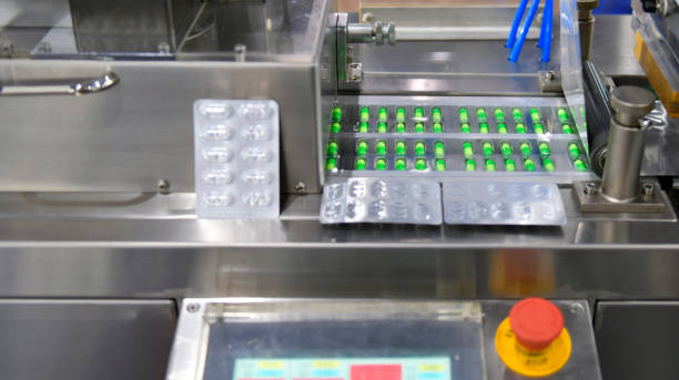 istock Green capsule medicine pill production line 1285400317