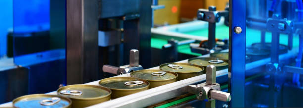 istock Canned food products on conveyor belt in distribution warehouse. parcels transportation system concept 1285400337