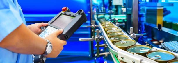 istock Manager check and control automation canned food products on conveyor belt 1285400343