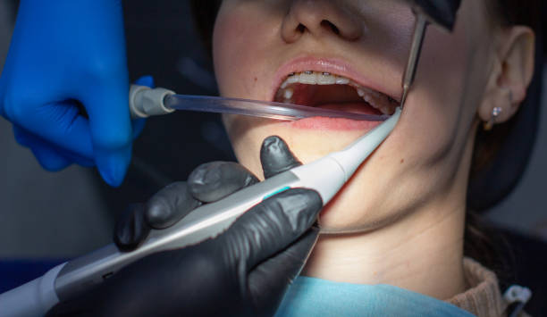 istock A woman at a dentist's appointment to replace arches with braces. 1285401848