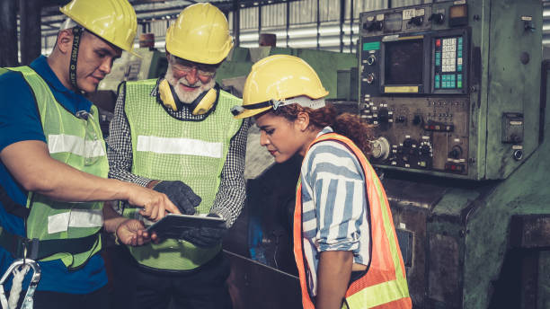 istock Group of factory workers using machine equipment in factory workshop 1285404121