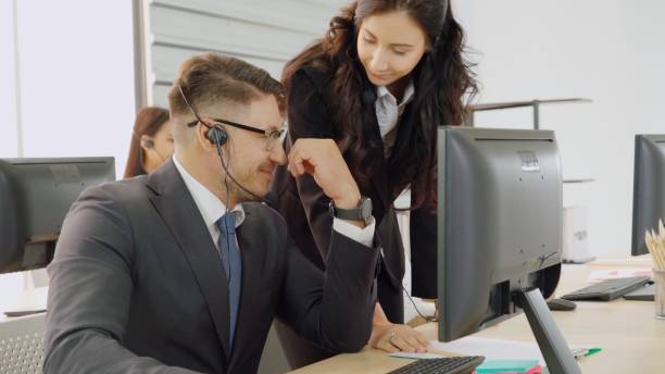 istock Business people wearing headset working in office 1285404821