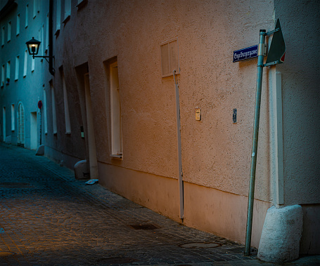 Old town street with dusk in narrow alley and cosy lantern with light. Germany, Bavaria, Europe travel.