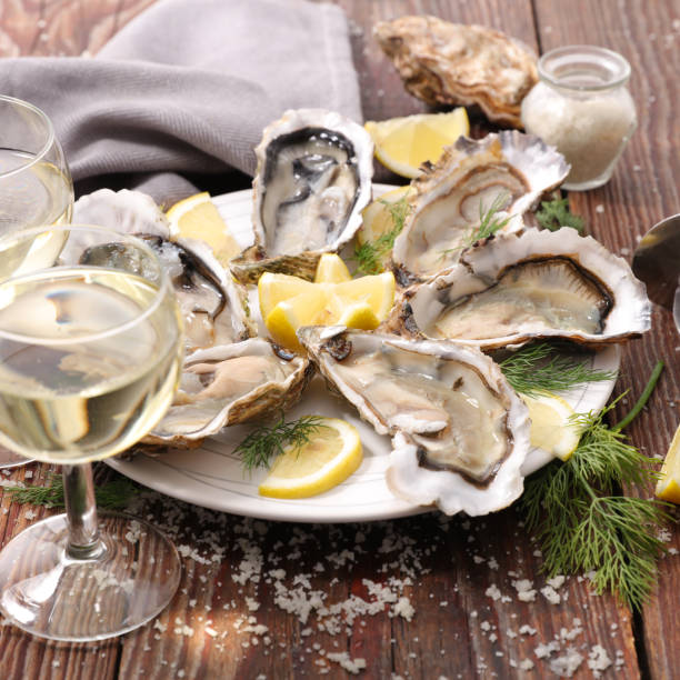 oyster and champaign on wood background oyster and champaign on wood background oyster photos stock pictures, royalty-free photos & images