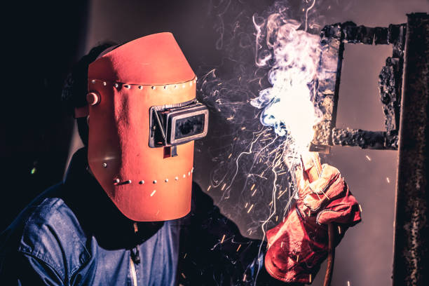 Metal welding steel works using electric arc welding machine Metal welding steel works using electric arc welding machine to weld steel at factory. Metalwork manufacturing and construction maintenance service by manual skill labor concept. argon stock pictures, royalty-free photos & images