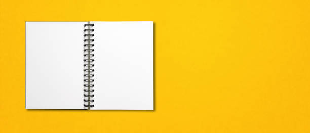 istock Blank open spiral notebook isolated on yellow banner 1285408743