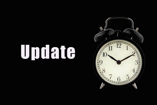 istock UPDATE text with alarm clock on black background. Business Concept 1285408884