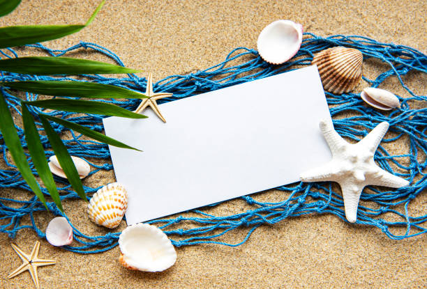 istock Empty blank of sheet paper on beach sand with sea shells 1285410844