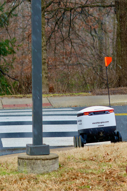 single food delivery robot at crosswalk, george mason university - george mason imagens e fotografias de stock