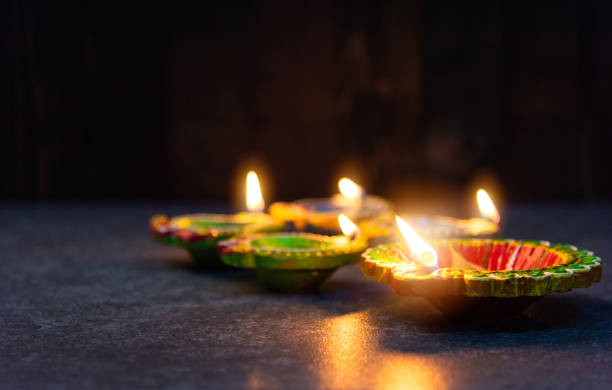 istock clay lit light a fire already on Diya or oil lamp 1285412994