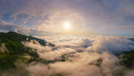 Aerial view of sunrise above fluffy sea fog misty clouds with mountain hill from Phu Tub Berk, Khao Kho, Phetchabun with sunlight. Abstract nature landscape background in morning time.