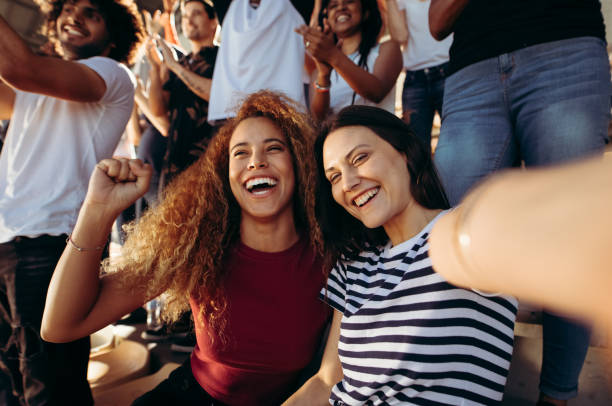 istock Excited female spectators making a selfie at stadium 1285415629
