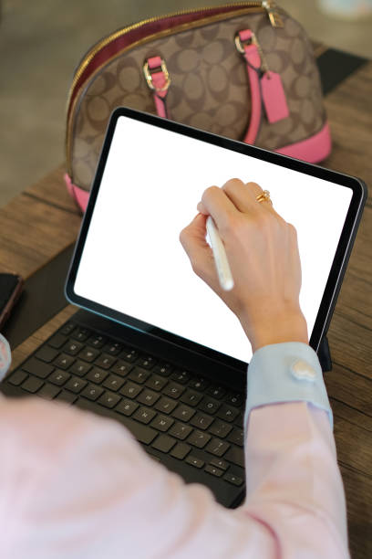 istock Cropped shot of business woman is working on her computer tablet with  in office. Blank screen for your advertising text message 1285419829