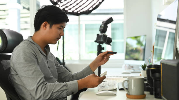 istock A man freelance photographer is working on his project at office desk with multiple computers. 1285419880