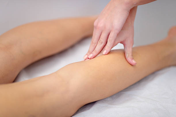 istock Therapist's hand massaging patient's calf 1285420925