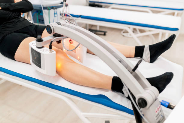 istock Treating human knee with electromagnetic radiation therapy 1285421020