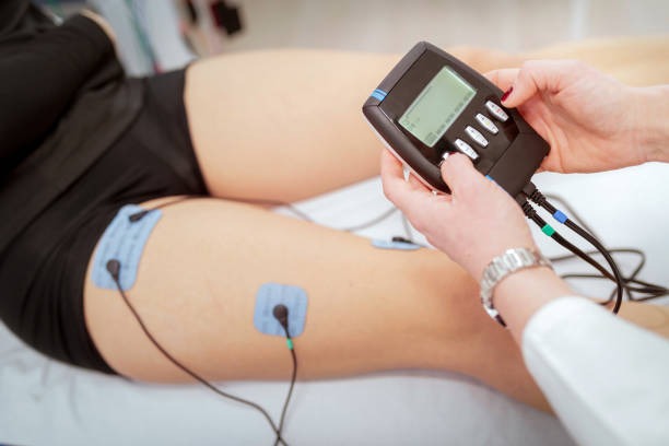 istock Turning on electrostimulation of patient's leg on controlling device 1285421076