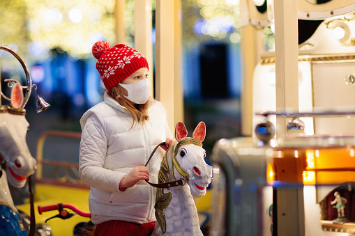 Kids at Christmas fair. Child at Xmas market.