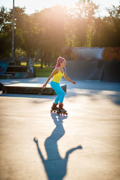 istock Woman roller skating at skateboard park 1285424518