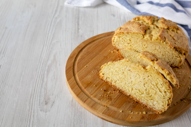 istock Homemade Irish Soda Bread on a bamboo board on a white wooden surface, side view. Copy space. 1285426497