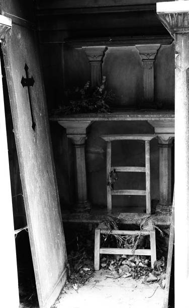 istock dramatic open grave with a serious old woman and the door torn u 1285426519