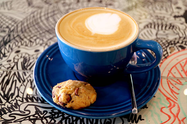 Cup of cappuccino coffee with a chocolate chip cookie