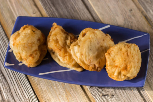 istock Close up of fried cod served on hand painted blue plate. Christmas recipe. 1285427272
