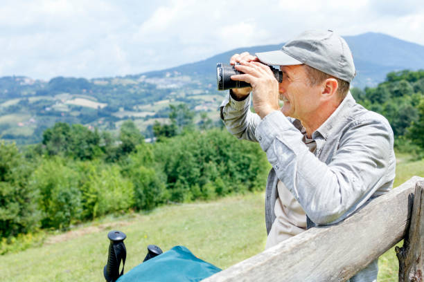 istock Senior man resting and observing nature through binoculars 1285429339