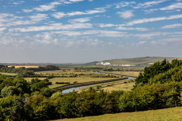 A South Downs View with the River Ouse and Green Fields Looking down at the River Ouse winding through the Sussex countryside, on a sunny summers day ouse river photos stock pictures, royalty-free photos & images