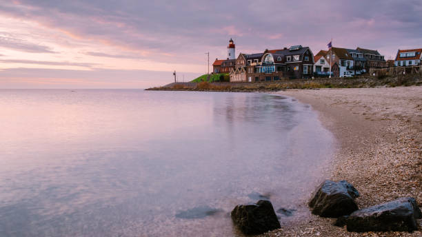 istock Urk village during sunset, Urk Flevoland Netherlands lighthouse and harbor lights during winter at the former Island of Urk 1285430683