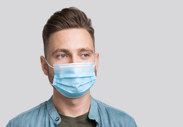 istock Portrait of a young man wearing protective face mask 1285432430