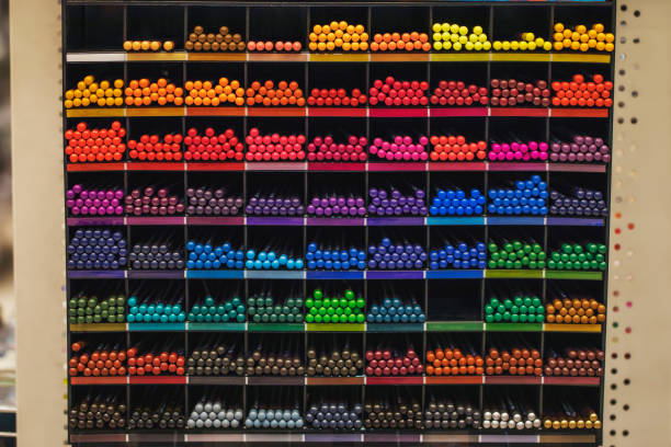 istock Color palette. Multi-colored pencils on a shelf in a bookstore. 1285432440