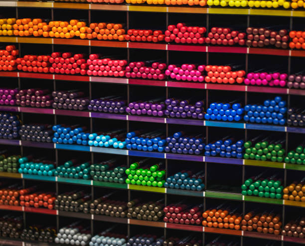istock Color palette. Multi-colored pencils on a shelf in a bookstore. 1285434090