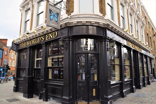 View of the outside of the Churchill Arms in London. Large amounts of flowers and UK decorations can be seen on the exterior. The Churchill Arms, the London's most famous pub. Scenic victorian pub in Notting Hill, Kensington. The London's most colourful pub.