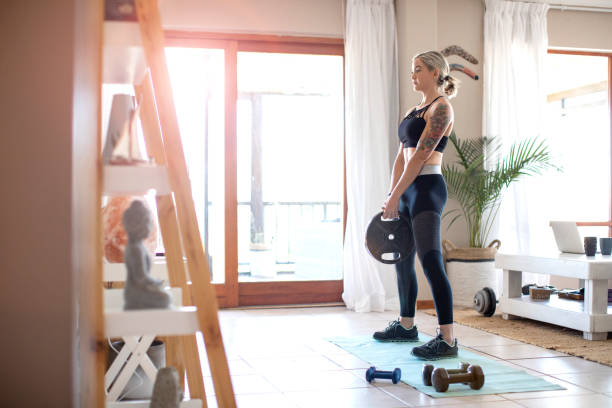istock A Young woman doing weight training at home. 1285435742
