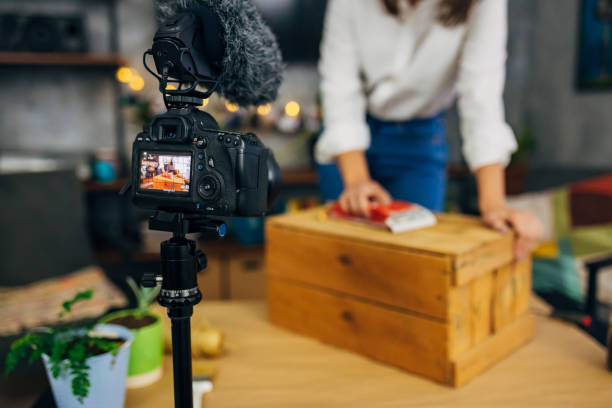 istock Female carpenter filming DIY tutorial, while showing her followers proper whey to paint decoration for your home 1285436138