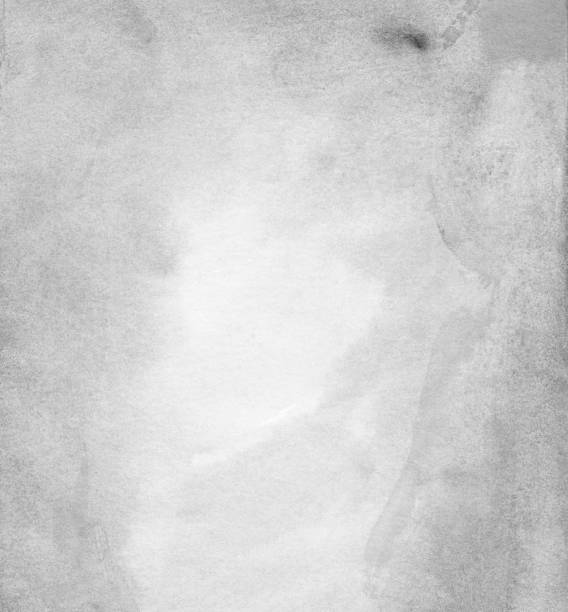 istock Watercolor light gray background texture with space for text. Grey stains on paper overlay. 1285436968