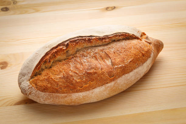 istock Delicious fresh bread on a wooden table. 1285437147
