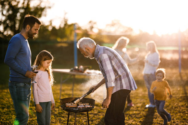 istock Extended family having barbecue time in the front yard. 1285441467