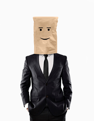 Happy businessman with paper bag over his head