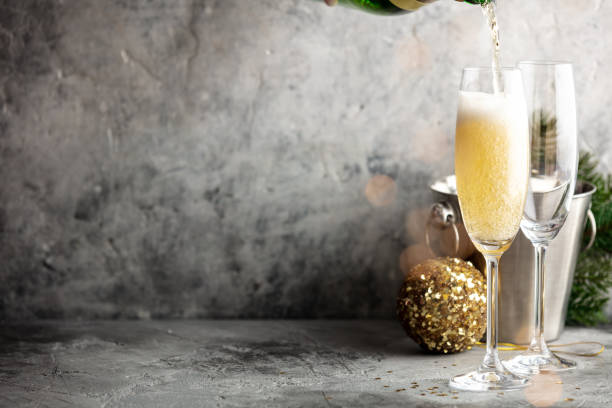 istock Champagne pouring into glasses and Christmas decorations 1285443656