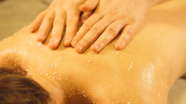 istock Massage master making salt scrub massage. Spa and massage concept. 1285443852