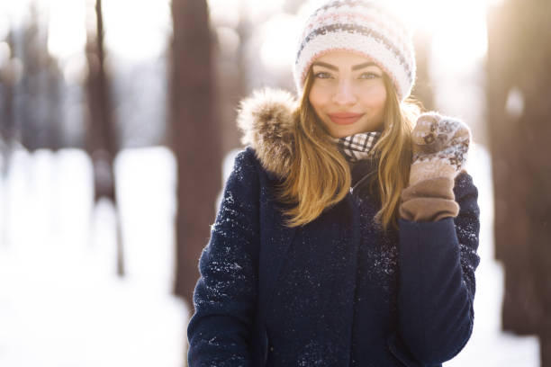 istock Young lady in winter clothes posing with joy outside in the park. 1285443861
