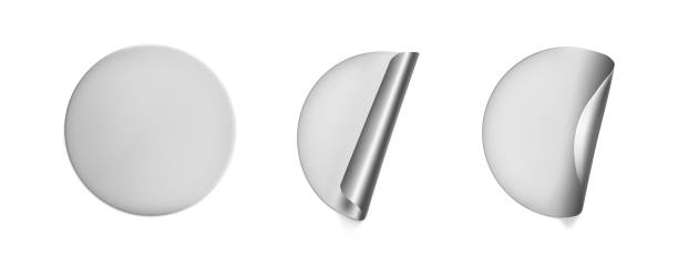 istock Silver round crumpled stickers with peeling corner mock up set. Adhesive silver foil or plastic sticker label with wrinkled effect on white background. Blank template label tags. 3d realistic vector 1285445011
