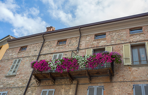 Colorful flowers adorning a balcony in Italy in summertime