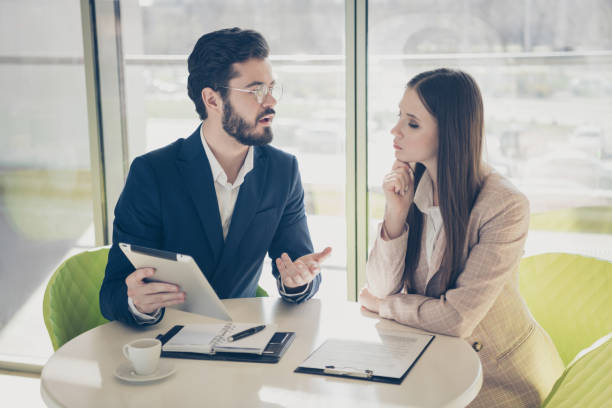 istock Portrait of his he her she two nice stylish classy smart clever skilled people specialist web search analysing data market human money capital at light white workplace workstation 1285448708